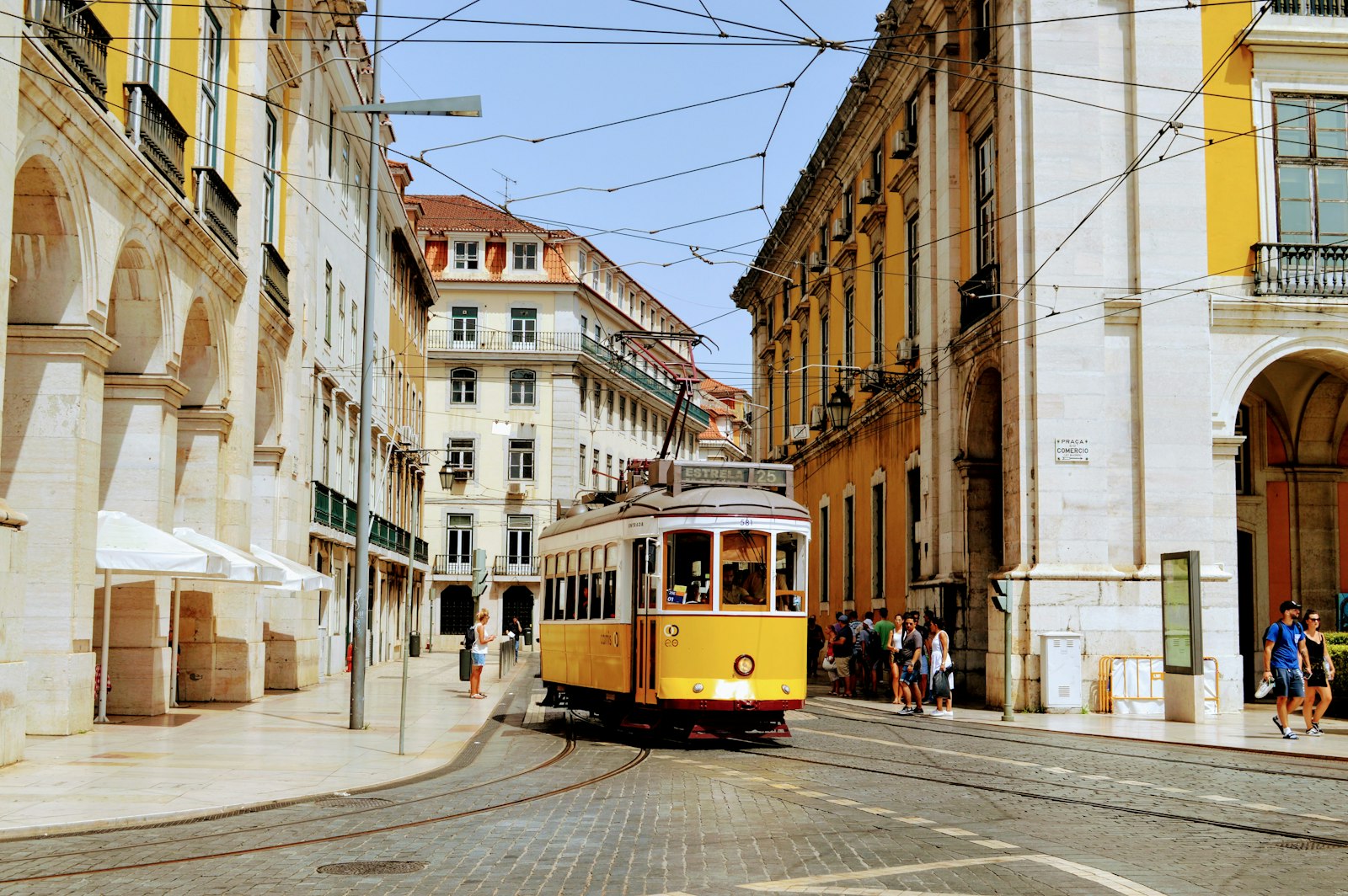 Iconic yellow tram climbing a street in Lisbon, Portugal